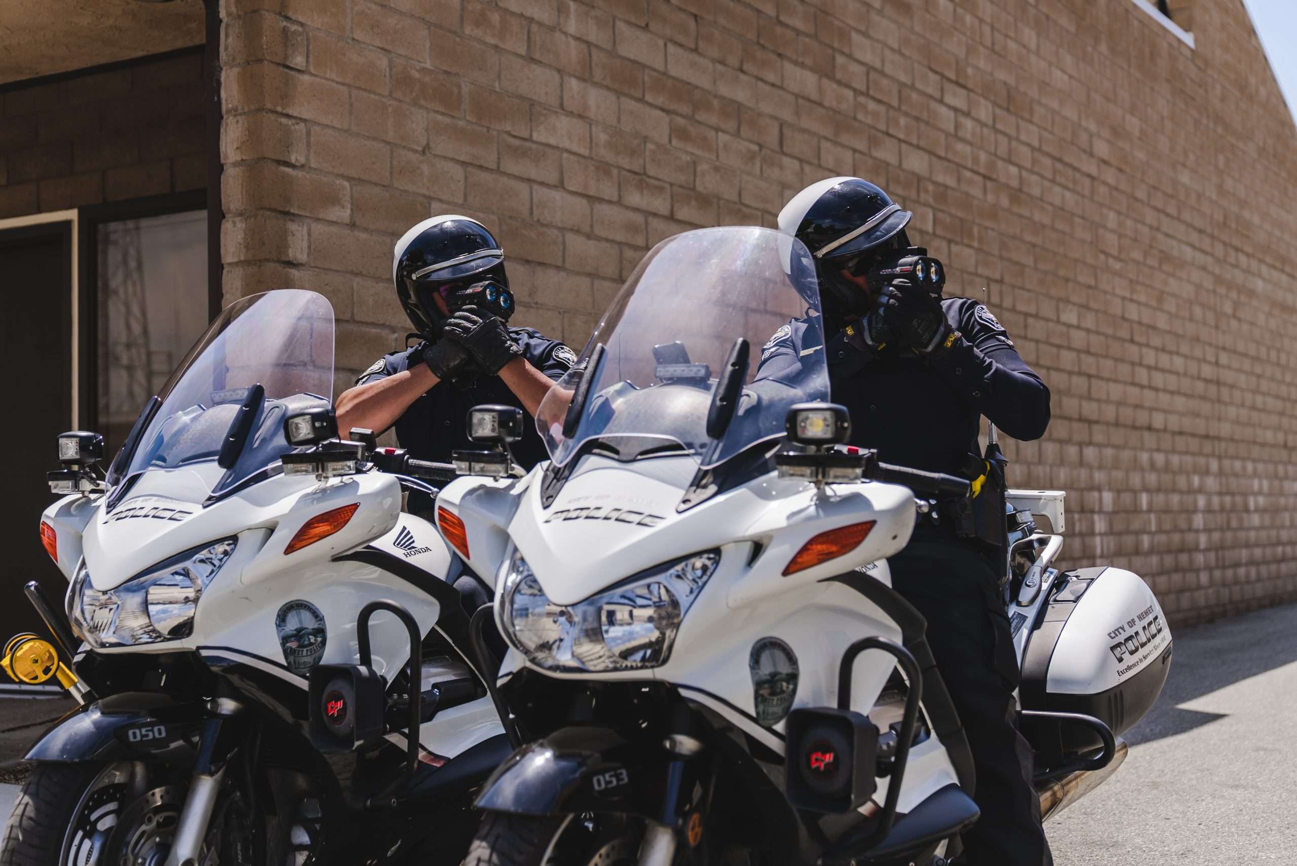Two Hemet Police Department Motor Officers use LIDAR to determine the speed of approaching vehicles